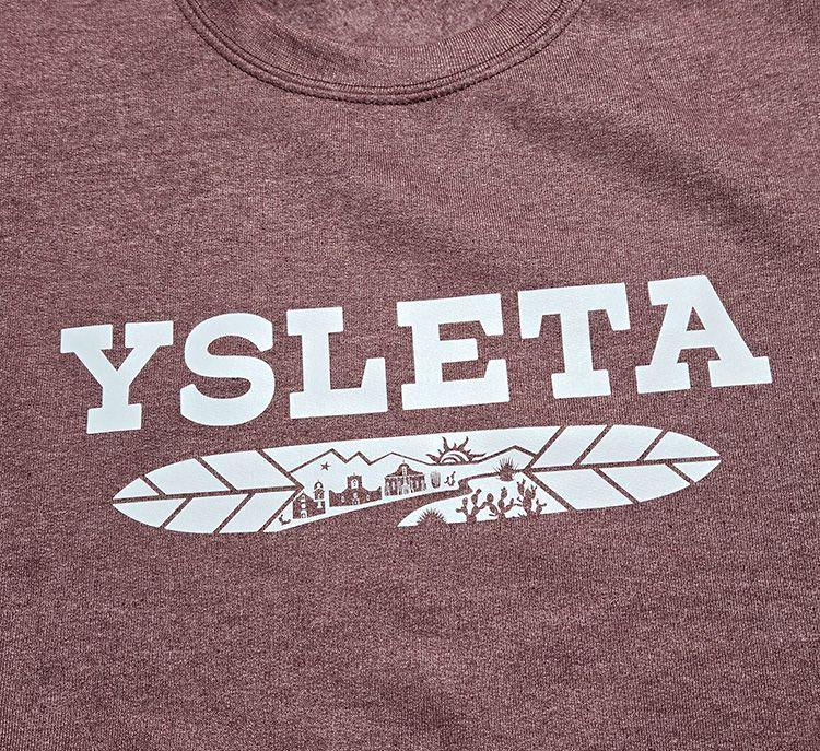 Heather maroon crewneck sweatshirt by Vanessa Clark featuring Ysleta Feather design, El Paso souvenirs clothing.