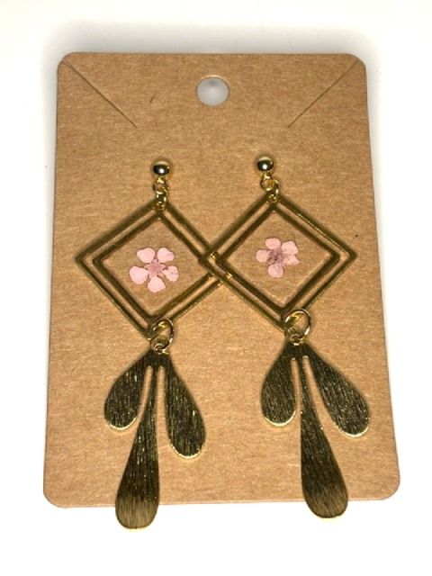 Gold geometric dangling earrings with pressed flower accents by Melissa Cortinas, featuring a modern and elegant jewelry design.
