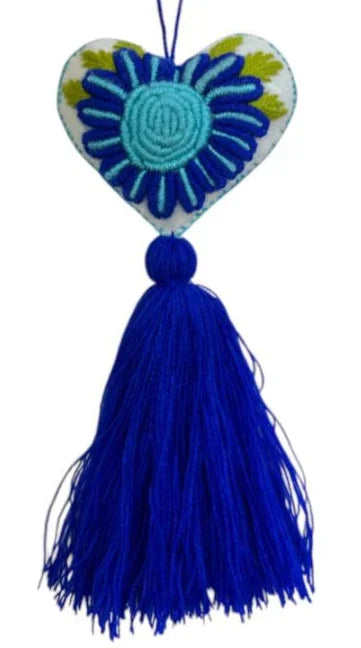 Handmade embroidered heart charm on colorful Mexican textile, designed by Jose Alberto Chavez for bag accessories.
