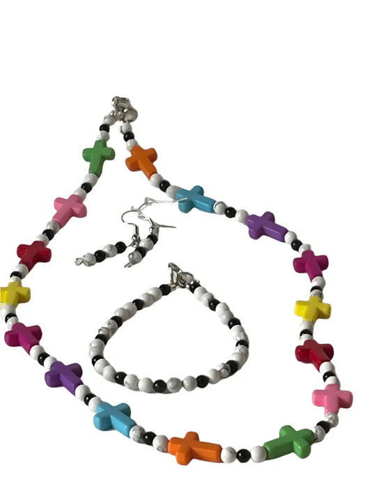 Faith-inspired multi-color cross jewelry set with necklace, earrings, and bracelet by Sylvia Leroux, featuring vibrant cross designs