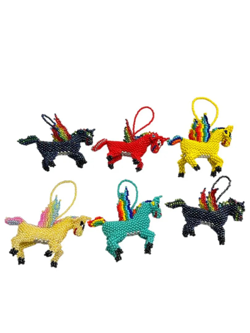 Handcrafted beaded unicorn charm with Mexican embroidery and tassel, designed by Jose Alberto Chavez for bag accessories.