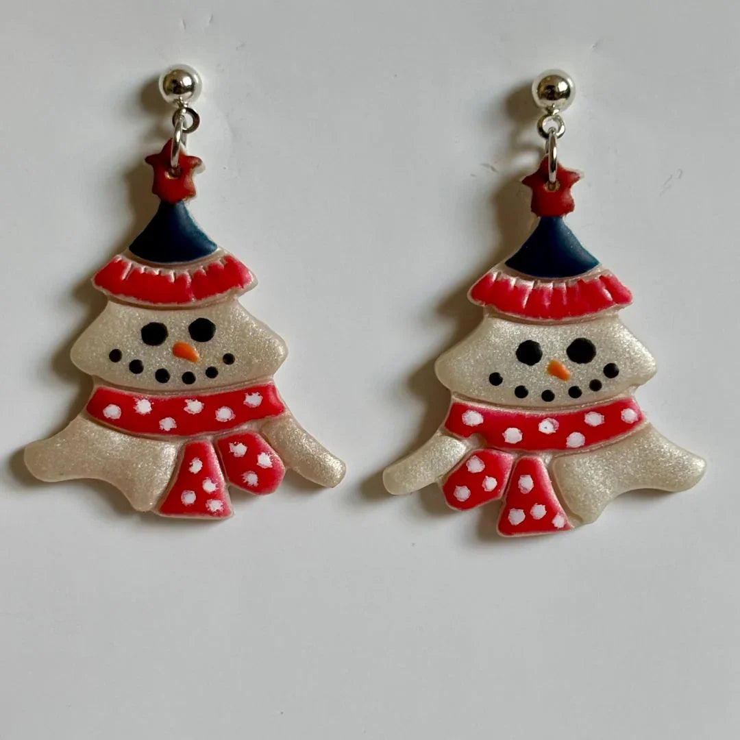 Handcrafted clay melted snowman dangle earrings with stainless steel posts by Melissa Cortinas, showcasing winter-themed jewelry design.