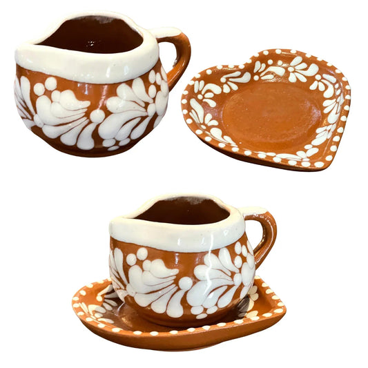 Handcrafted red clay heart-shaped coffee cup and plate set with white design, perfect for home or garden use.