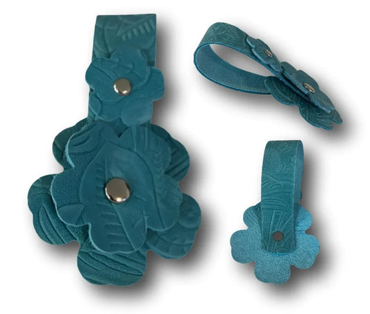 Handcrafted leather flower tassel keychain with silver snap from Consuelo Barraza, featuring faith-inspired artisan design.