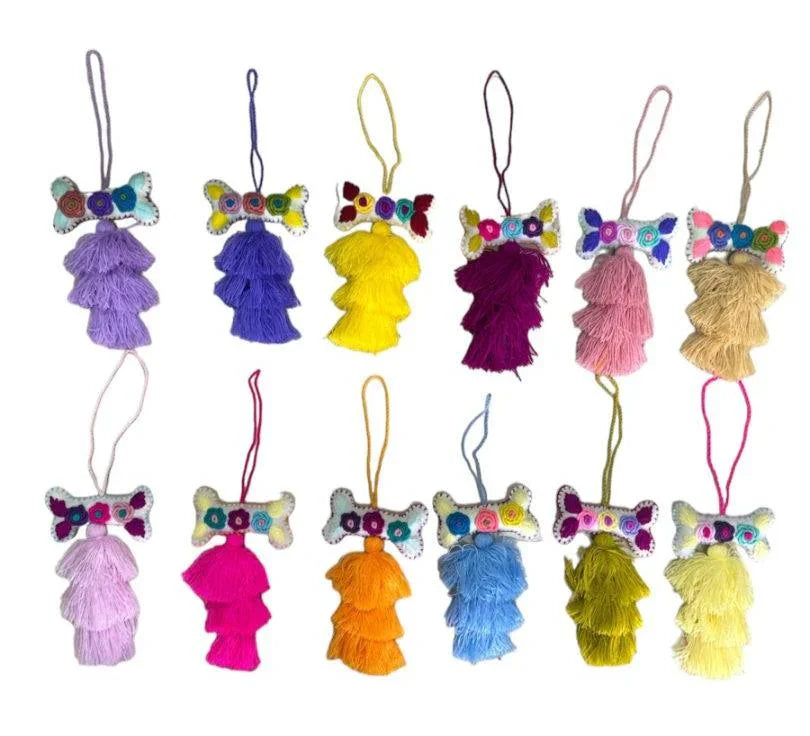 Handcrafted Mexican embroidered dog bone charm with tassel, artisan accessory by Jose Alberto Chavez for bag decoration.