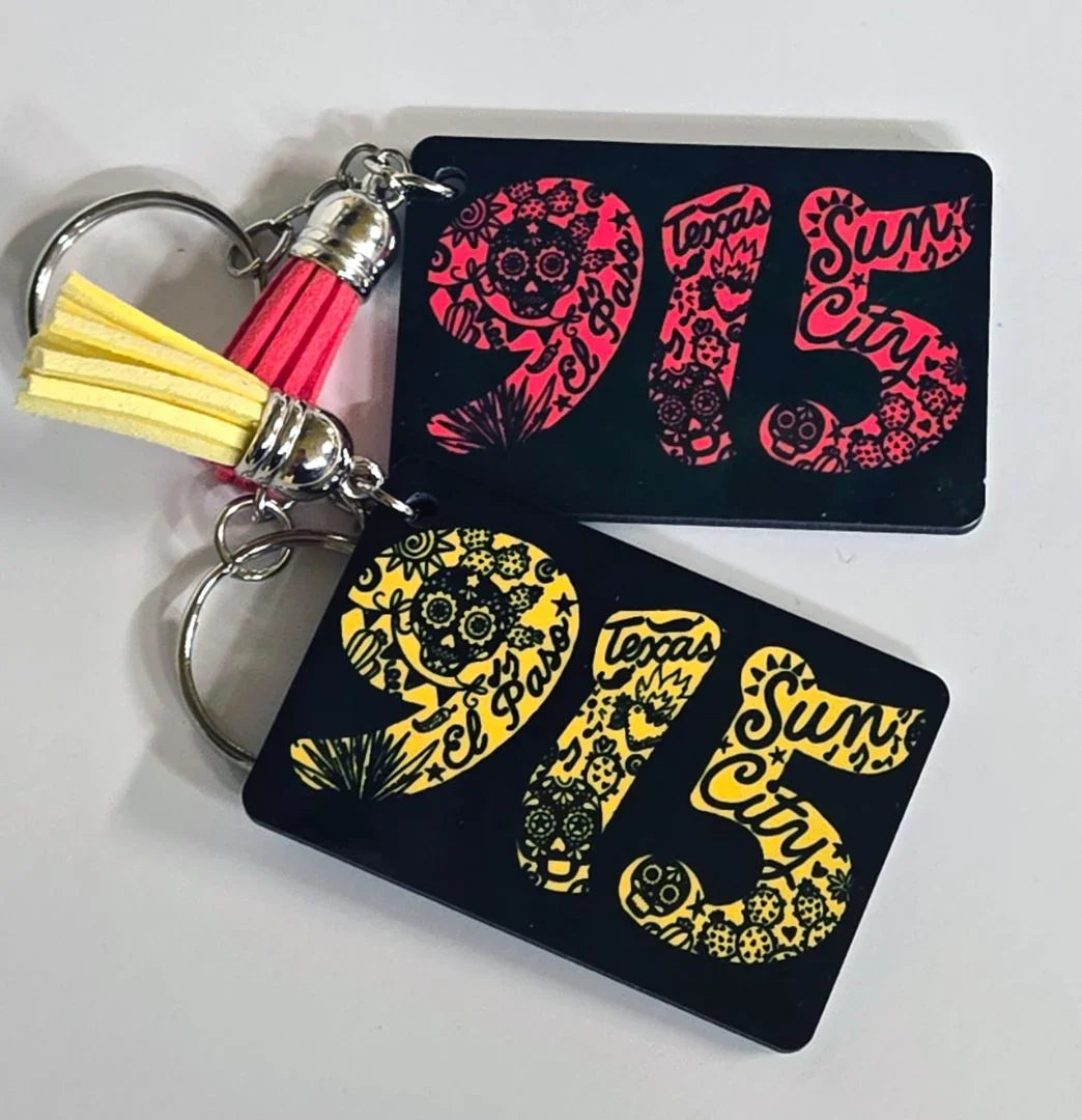 Colorful El Paso souvenir keychain by Vanessa Clark, featuring yellow or pink designs, from the El Paso souvenirs and accessories collection.