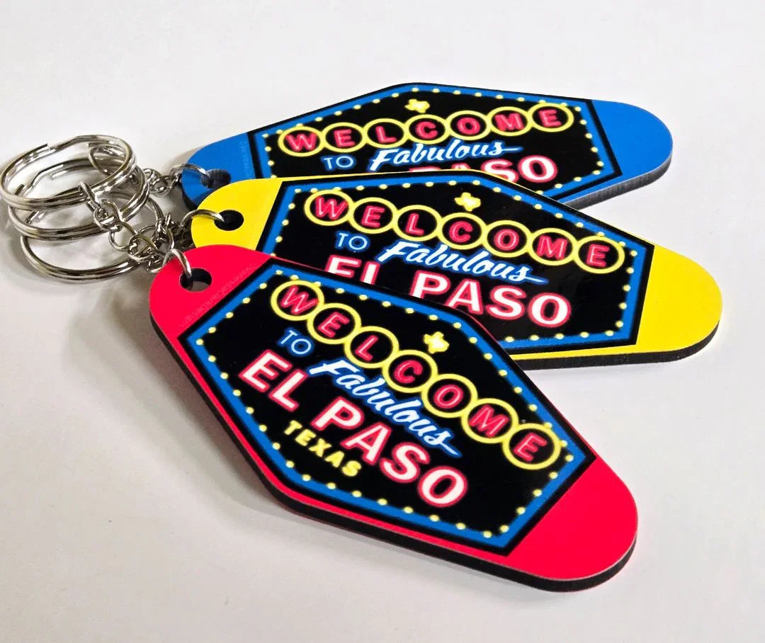 El Paso neon-style motel keychain with "Welcome to El Paso" sign, double-sided sublimated design by Vanessa Clark.