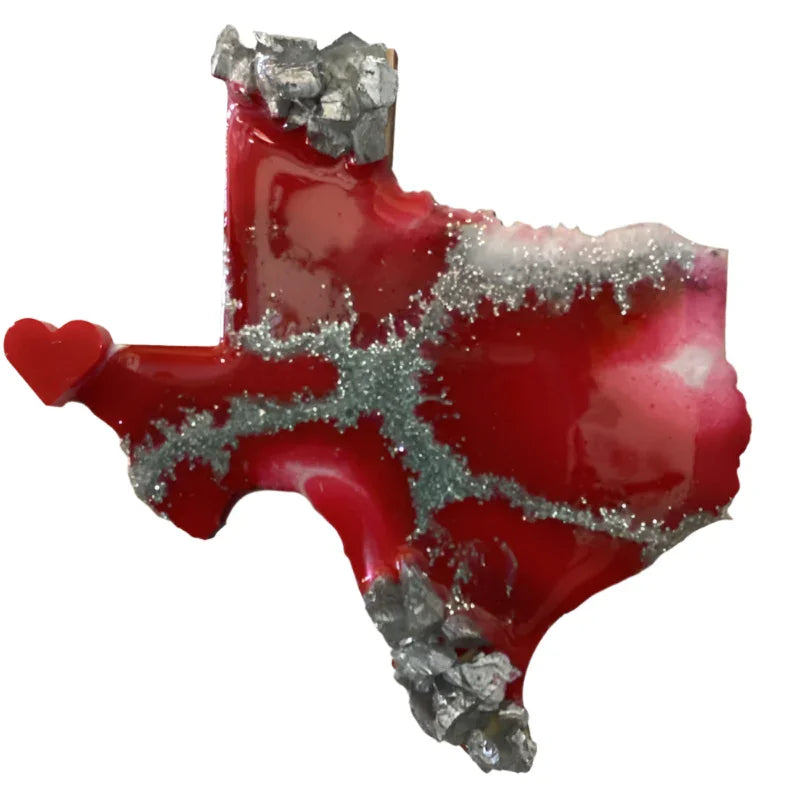 Texas-shaped resin magnet with red and silver tones, featuring a wood texture and Brigitte Rosson branding.