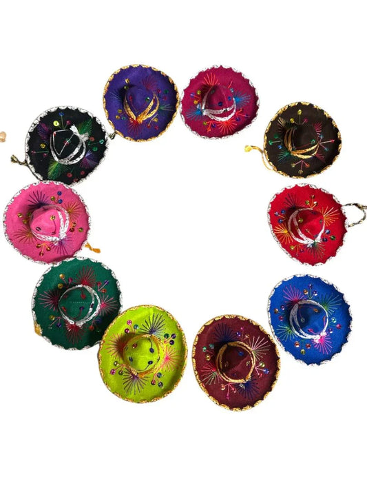Assorted velvet mini Charro hats with shiny accents for Mexican party decor, handmade by Jose Alberto Chavez.