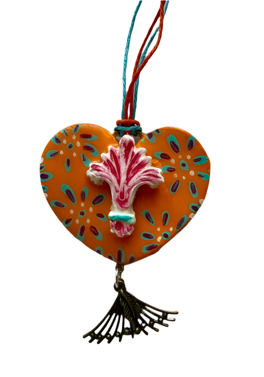 Orange air dry clay Le Fleur heart ornament with short strings, 2x2.5 inches, handcrafted home and garden decor by Lorena Williams.