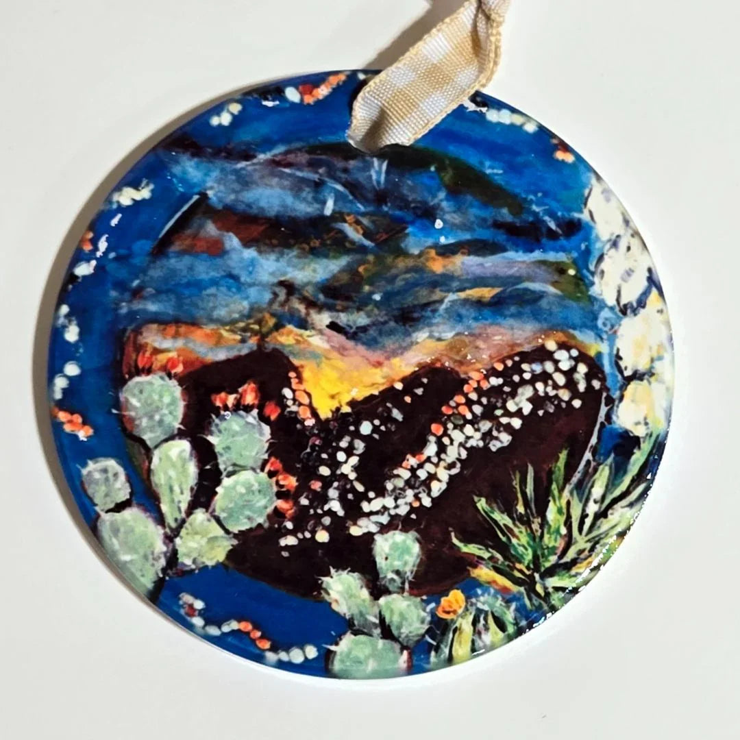 Colorful round ornament with vibrant sublimated art and ribbon detail, designed by Vanessa Clark.