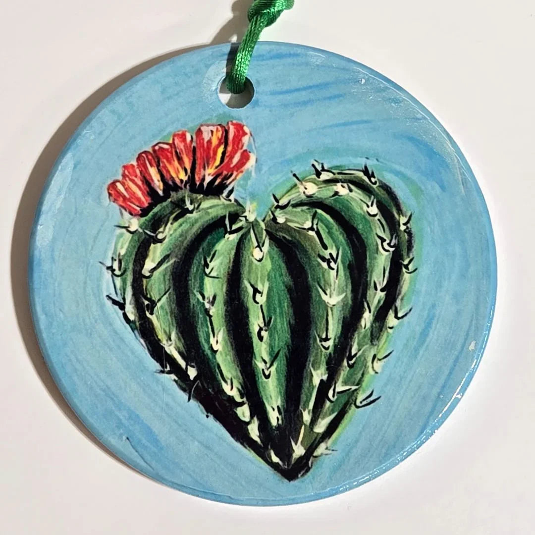Colorful round ornament by Vanessa Clark featuring high-color sublimated original art with vibrant ribbon accents.