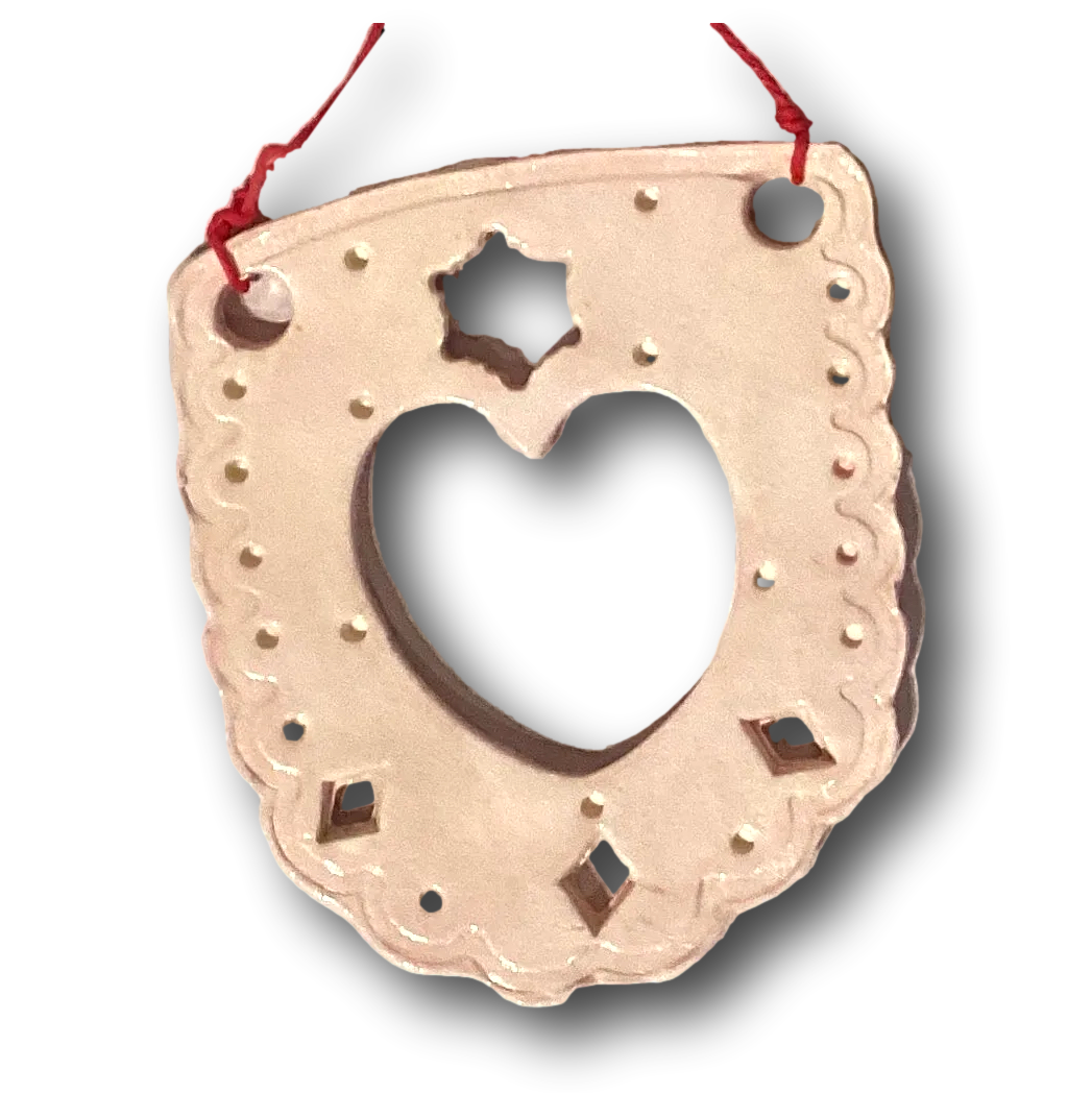 Pastel pink ceramic ornament with papel picado style design by Lorena Williams, ideal for home and garden décor.