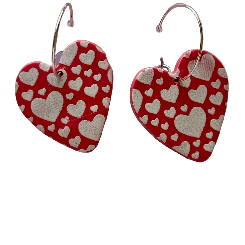 Pink heart-shaped polymer clay earrings by Lorena Williams, 1.5 inches long, with a delicate and stylish jewelry design.