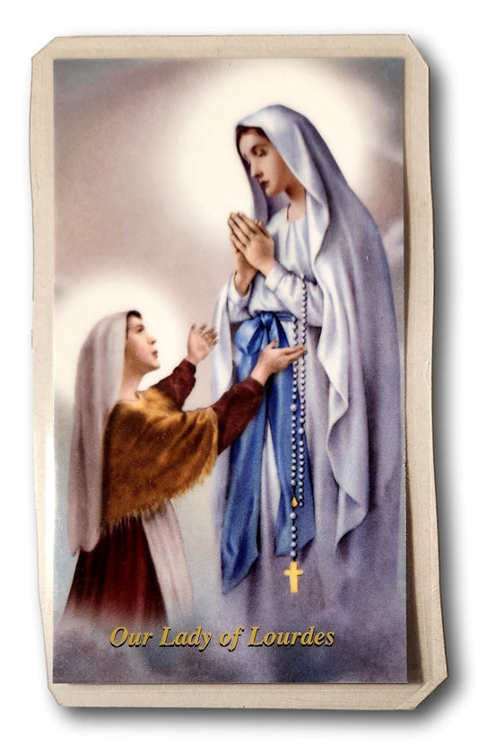 Laminated Catholic prayer card featuring Our Lady of Lourdes with religious imagery, suitable for Christian devotion.