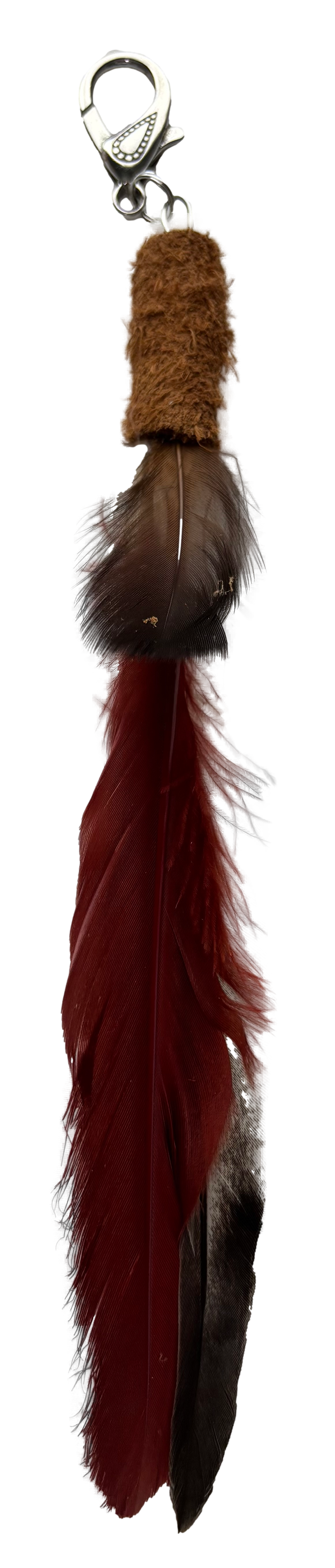 Red feather tassel keychain from Consuelo Barraza featuring vibrant feathers and a stylish accessory for bags or keys.
