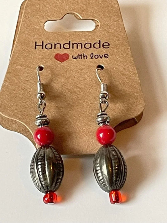 Red seed bead and silver football charm earrings by Sylvia Leroux, featuring 1.75-inch dangle jewelry accessory.