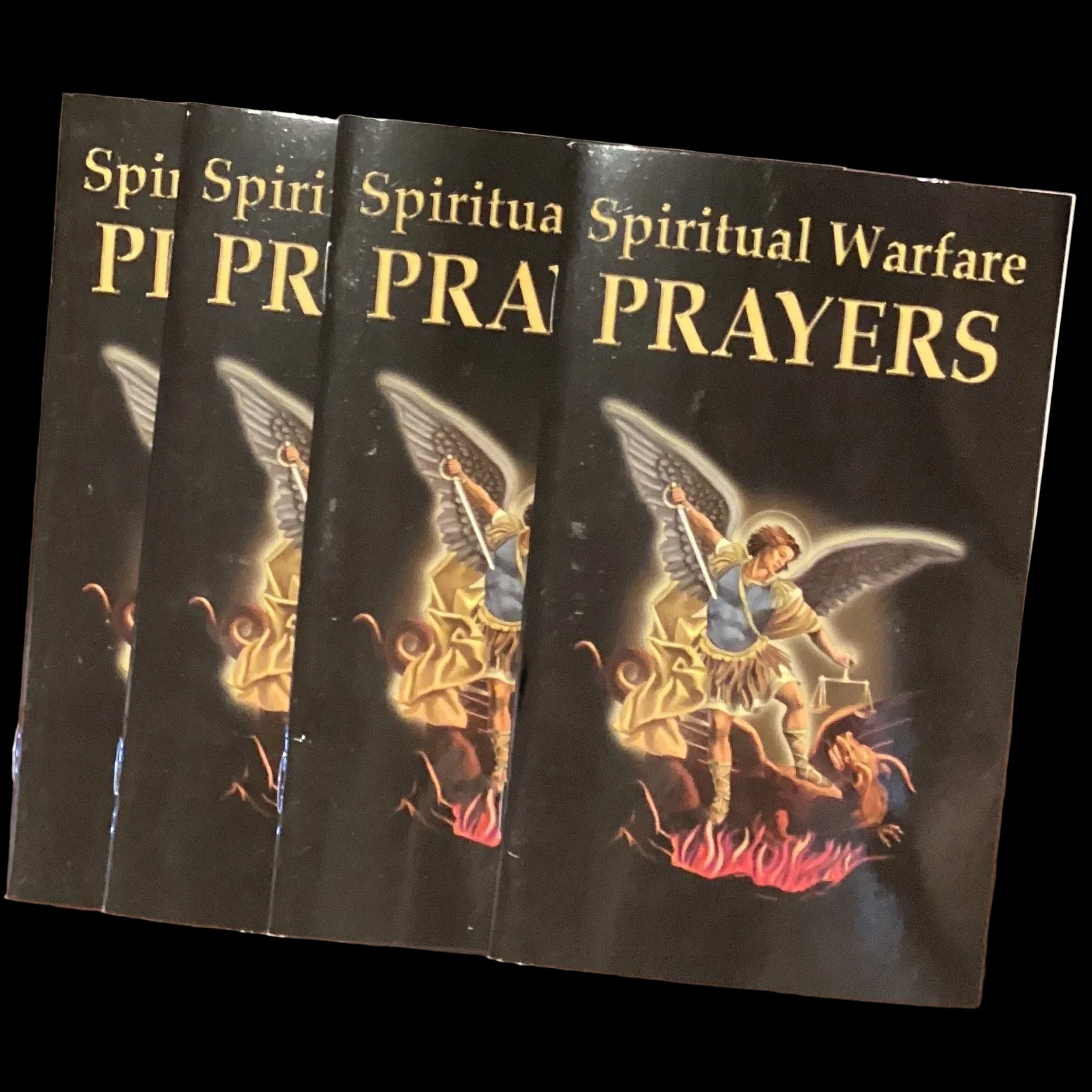 English Spiritual Warfare Prayers Book by Ysleta Mission Gift Shop, open to pages with prayer text and spiritual imagery.