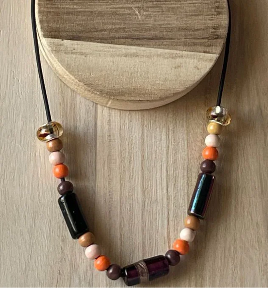 Brown and orange wooden bead necklace with glass beads on black cord, artisan style jewelry by Sylvia Leroux.