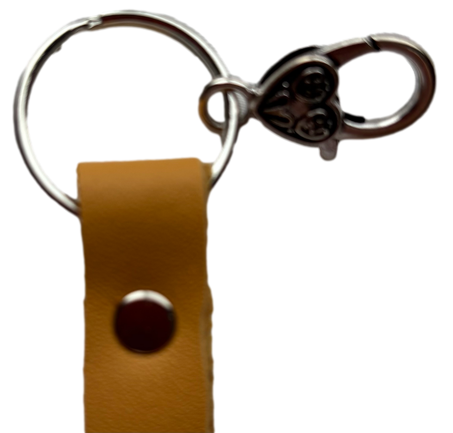 Yellow butterfly keychain by Consuelo Barraza attached to a handbag, featuring bright yellow wings and a silver keyring.